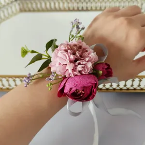 Artificial flower wrist corsage detail view, elegant pink and rose red floral wristband for party.