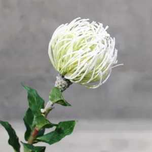 Artificial pin cushion flower detail shot, single branch white flocked floral decoration.