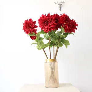 Artificial red dahlia flower bouquet in ribbed glass vase for home decor and photography props.