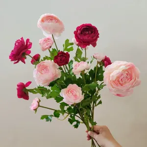 Artificial silk flower bouquet detail, multi-head pink ranunculus floral arrangement background.