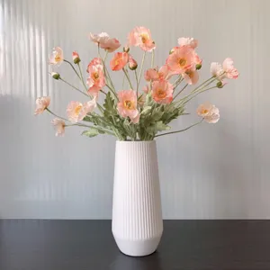 Artificial Iceland poppy bouquet in a white fluted vase for home decor, coral pink.