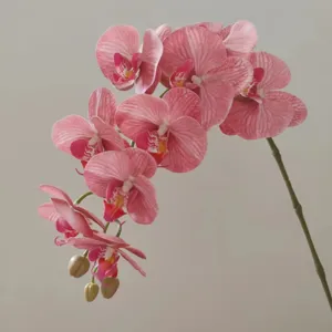 Detailed shot of a 3D printed artificial pink phalaenopsis orchid branch for decoration.
