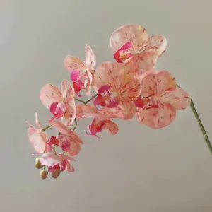 Artificial phalaenopsis orchid branch, pink speckled flower detail for home decor and styling.
