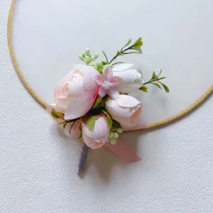 Close-up of pink artificial flower boutonniere detail, wedding corsage accessory.