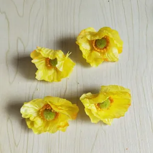 Detailed close-up of four yellow artificial poppy flower heads for DIY crafts and hair accessories.