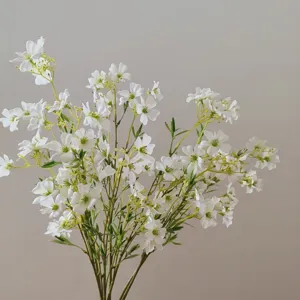 Artificial clematis small flowers detail shot, white silk floral bouquet for home decor and DIY crafts.