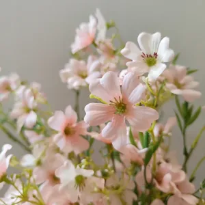 Close-up detail of artificial pink micro flowers, soft fabric petal texture for DIY decor.