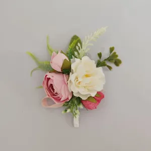 Artificial rose flower boutonniere detail view, elegant wedding groom suit corsage decor.