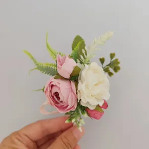 Artificial pink and white rose boutonnière detail, elegant wedding floral accessory