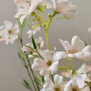 Close-up detail of artificial clematis flowers, delicate pink petals and green stems, perfect for home