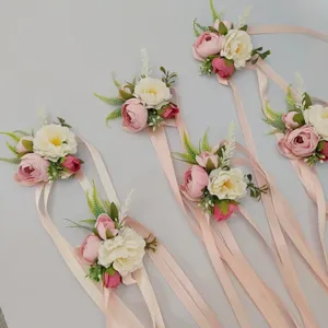 Artificial rose wrist corsage set with pink ribbons for wedding bridesmaid and groom boutonniere