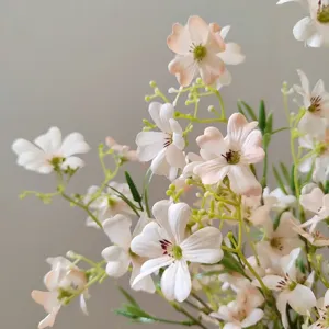 Close-up of delicate artificial clematis flowers, soft pink petals, perfect for floral crafts.