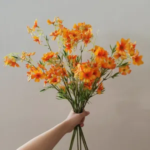 Close-up detail of artificial orange clematis flower bouquet, ideal for home decor photography.