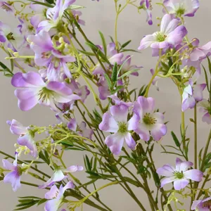 Detail view of artificial spring small flowers, silk clematis branches for home decor and DIY.