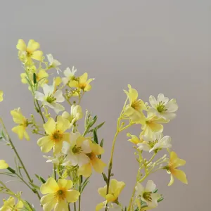 Artificial silk flower detail shot featuring lovely yellow and white clematis blossoms for decor.