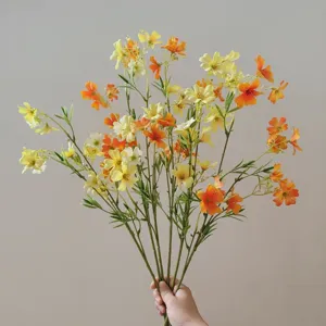 Detail shot of the 12-head artificial clematis bouquet in yellow and orange, perfect for decor.