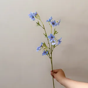 Detailed close-up of artificial blue clematis flower branch, perfect for DIY crafts and home decor.