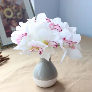 Artificial orchid flower bouquet in ceramic vase, beautiful home decor detail shot.