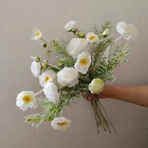Closeup detail of white artificial silk flower bouquet with green stems for home decor staging.