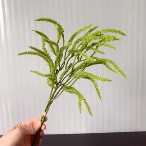 Artificial green fern branch detail shot, perfect for home decor and wedding floral design.