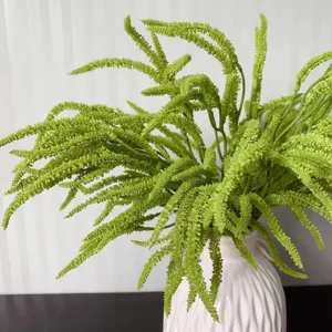 Artificial green fern plant detail view, realistic plastic leaves for home decor and vase.