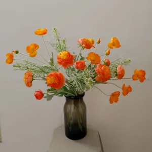 Orange artificial flower bouquet silk flowers in glass vase for home decor photography props