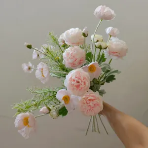 Detailed view of pink artificial flower bouquet with delicate petals and greenery for home decor.