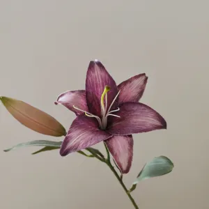 Closeup detail of 3D printed vintage purple artificial lily flower with bud and green leaves.