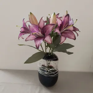 Artificial lily flower bouquet with black decorative vase for home decor and photography.