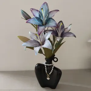 Detailed close-up of 3D printed vintage artificial lily flowers in a black art vase.