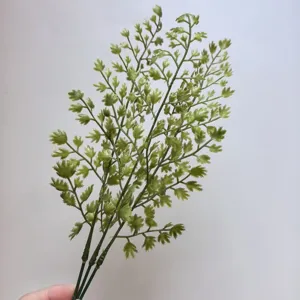 Primer plano detallado de tallos de plantas verdes artificiales para arreglos florales.