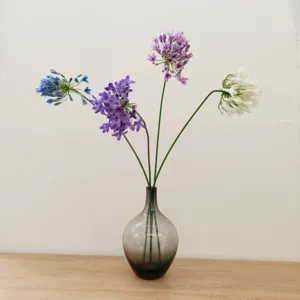 Artificial Agapanthus African Lily silk flowers in glass vase for home decor and photo props.