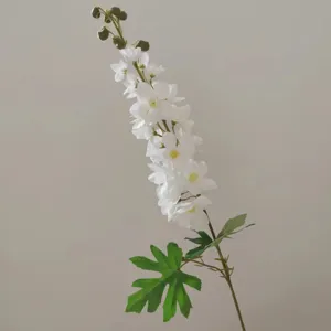 Detailed close-up view of single white artificial larkspur flower with realistic green stem.
