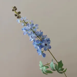 Detailed close-up of a single blue artificial delphinium branch with petals and buds.