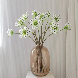 Artificial Star of Bethlehem flowers with brown glass vase for home decor and display.