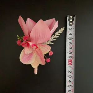Close-up detail of the elegant pink artificial orchid boutonnière, featuring realistic floral texture.