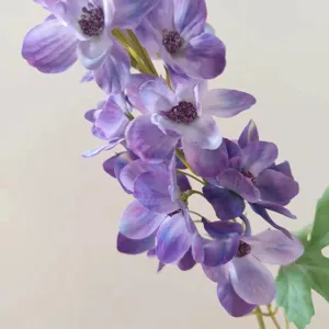 Detailed close-up view of purple artificial delphinium flower branch for home decor.