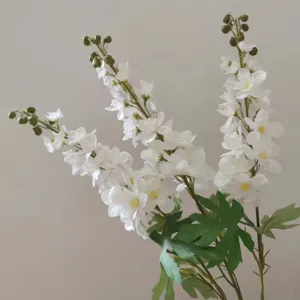 Detailed close-up of white artificial delphinium flowers, showcasing delicate petals and buds.