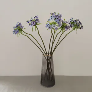 Detailed view of artificial Star of Bethlehem silk flowers in glass vase for home decor.