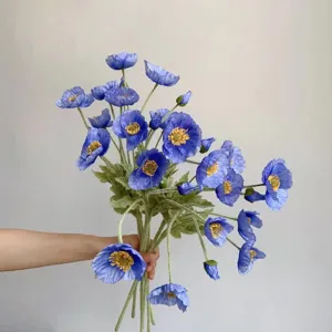 Blue artificial poppy flower bouquet detail shot, soft flocking stem and petal texture.