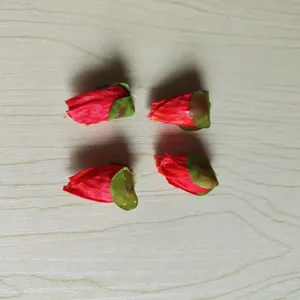 Detail view of 4 red artificial poppy flower buds, perfect for DIY crafts and hair accessories.