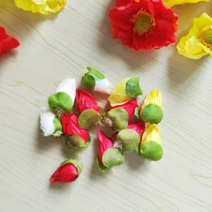 Close-up detail of artificial poppy flower buds and heads for DIY hair accessories crafts.