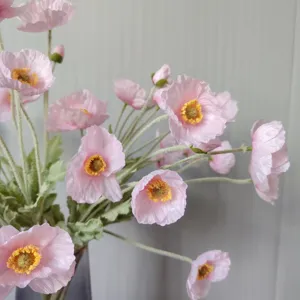 Detailed closeup shot of coral pink artificial Iceland poppy silk flowers with flocked stems.