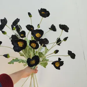 Detailed close-up of artificial black poppy bouquet with realistic flocked stems and petals.