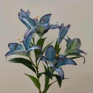 Detailed close-up of artificial blue lily flowers, showing realistic petal texture and leaves.
