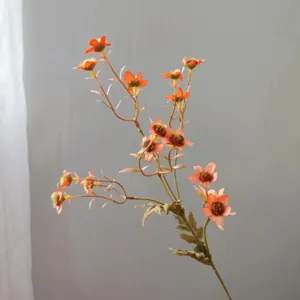 Close-up detail of artificial autumn chamomile flower branch, retro orange daisies.