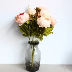 Detailed view of 13-head artificial peony flower bouquet in glass vase for home decor.