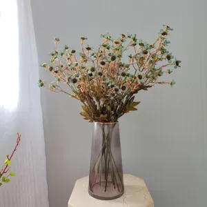 Autumn artificial daisy flowers detail view in glass vase home decor aesthetic setup.