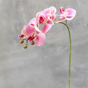 Detail view of pink artificial phalaenopsis orchid flower branch with 6 heads for home decor.