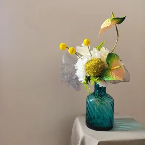 Détail de bouquet de fleurs artificielles, vase en verre moderne pour la décoration et accessoires photo.